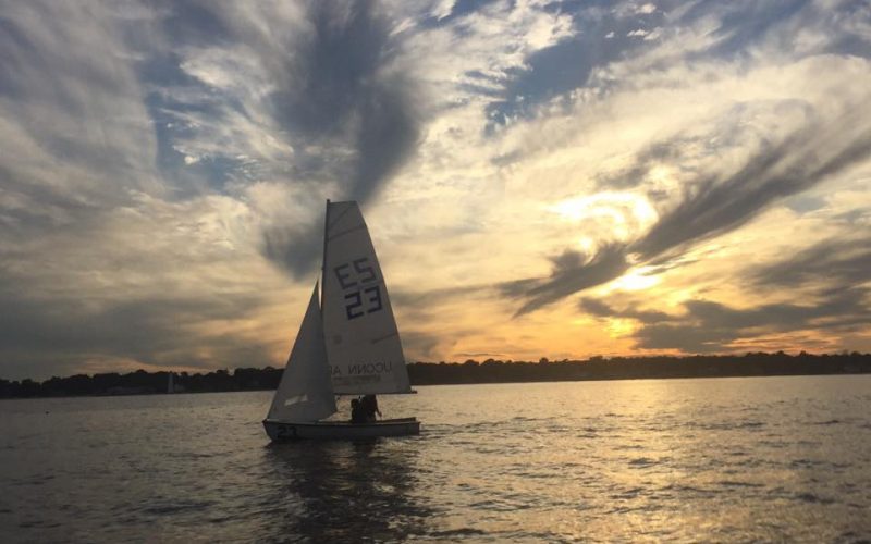 A phot of a sailboat at sunset