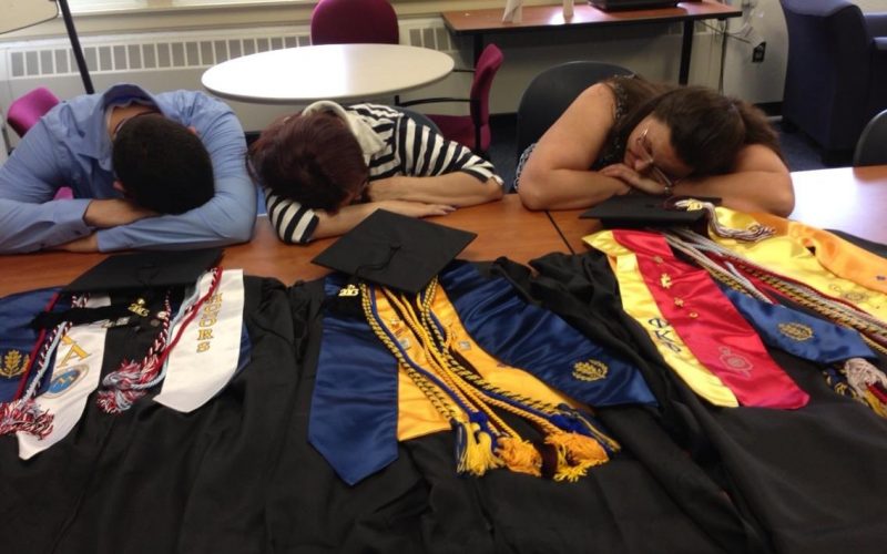 Photo of three tired Avery Point Graduates before commencement ceremony